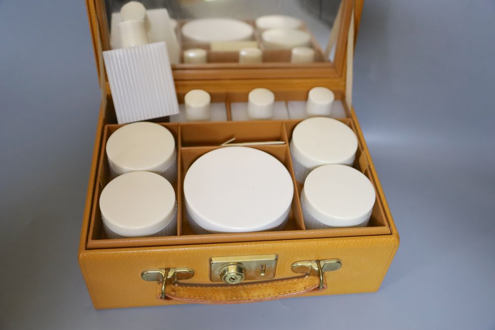 A 1960s plastic black and cream clutch bag, a black velvet bag and cream bag with Bakelite frame and a leather travel case